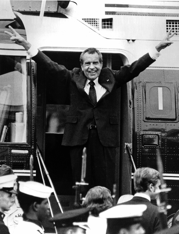 FILE - In this Aug. 9, 1974 file photo, Richard Nixon waves goodbye with a salute to his staff members outside the White House as he boards a helicopter and e resigns the presidency on Aug. 9, 1974. H ...