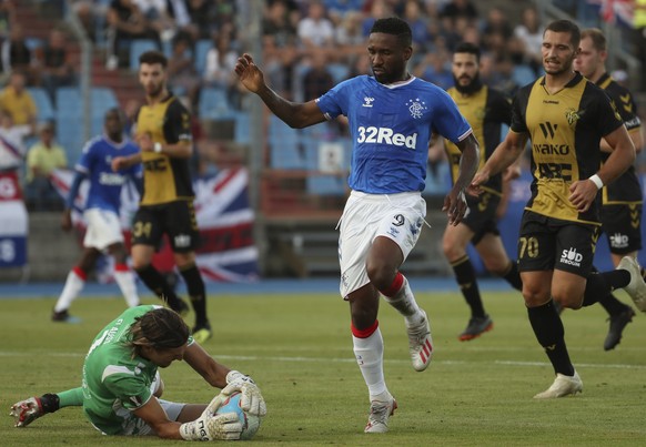 Progres&#039; goalkeeper Sebastien Flauss, left, goes in for a save against Rangers&#039; Jermain Defoe during a Europa League soccer match between Progres Niederkorn and Rangers at the Josy Barthel s ...