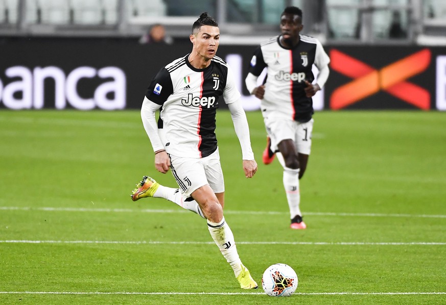 FILE - In this March 8, 2020 file photo, Juventus&#039; Cristiano Ronaldo runs with the ball during the last Serie A soccer match Juventus played before the coronavirus stop, at the Allianz Stadium in ...