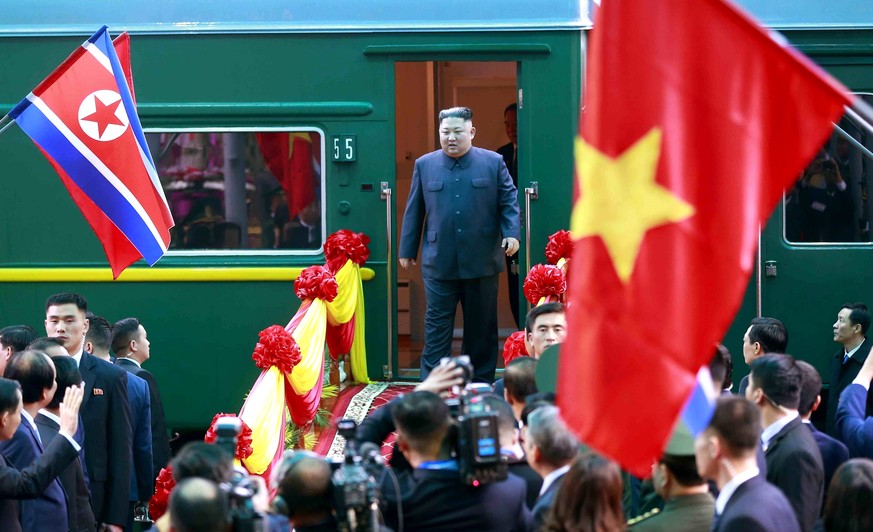 epa07397923 North Korean leader Kim Jong-un (C) steps off the train to be welcomed at Dong Dang Railway Station, to start his visit to Vietnam ahead of the US-North Korea summit hosted in Hanoi, at Do ...