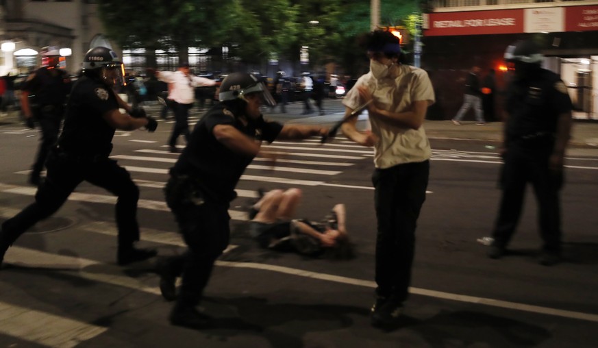 epa08457145 New York City Police officers arrest protesters during a demonstration about the arrest of George Floyd, who later died in police custody, in New York , New York, USA, 31 May 2020. A bysta ...