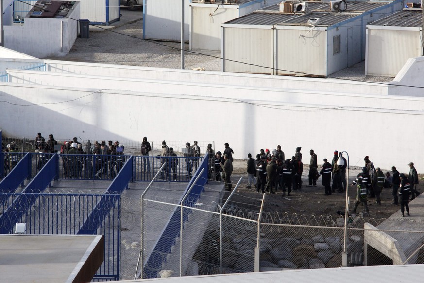 epa04109391 A large group of immigrants are seen at Moroccan territory after they where intercepted by Spanish border police at Ceuta, the Spanish enclave in the north of Africa, 04 March 2014. Almost ...