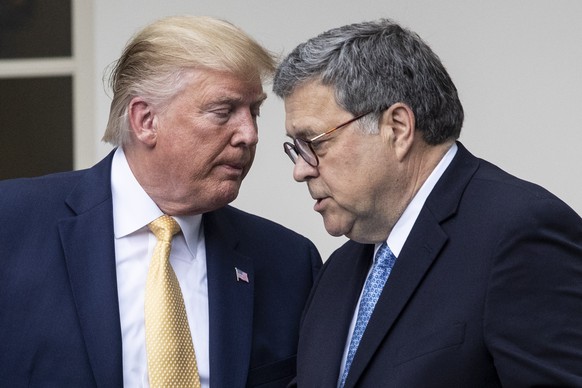 epa07883740 (FILE) - US President Donald J. Trump (L) hands over the podium to US Attorney General William Barr (R) while participating in an announcement on US citizenship and the census, in the Rose ...