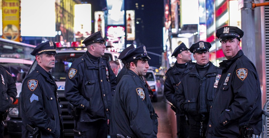 NEW YORK, NY - DECEMBER 4: New York City police pause as they block demonstrators on Times Square following yesterday&#039;s decision by a Staten Island grand jury not to indict a police officer who u ...