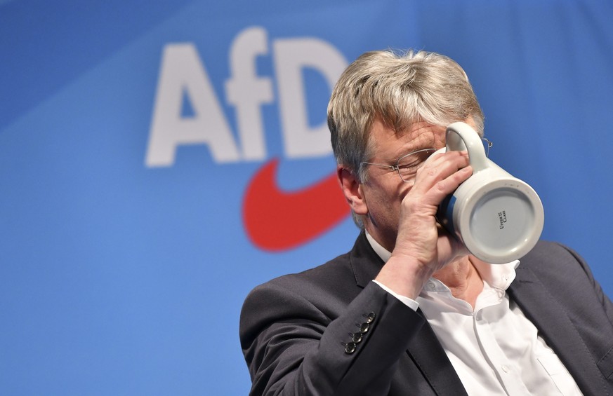epa07417250 Alternative for Germany (AfD) party co-chairman and top candidate for the European Parliament elections Joerg Meuthen drinks from a stein mug at the Political Ash Wednesday gathering of th ...