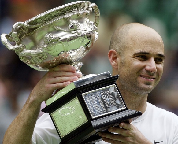 Andre Agassi displays the winner&#039;s trophy after his men&#039;s singles final victory by 6-2, 6-2, 6-1 against Rainer Schuettler from Germany at the Australian Open Tennis Championships in Melbour ...