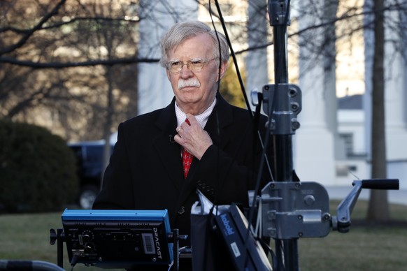 National security adviser John Bolton straightens his tie before an interview, Tuesday, March 5, 2019, at the White House in Washington. (AP Photo/Jacquelyn Martin)