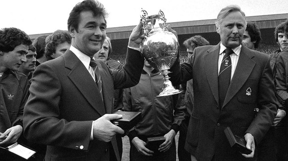 April 30, 1978 photo of Nottingham Forest soccer team manager Brian Clough, left, and assistant manager Peter Taylor, holding the English League Championship trophy after it had been presented to Fore ...