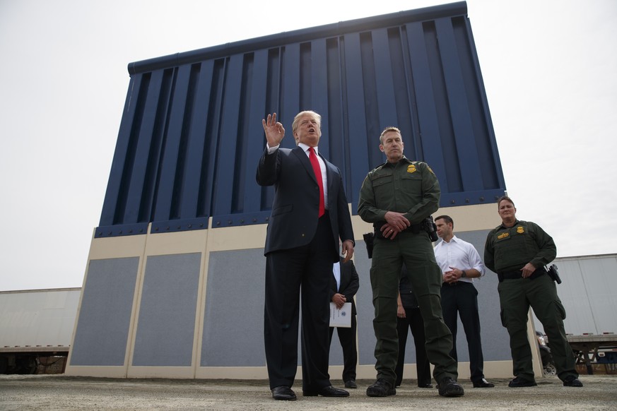 FILE - In this March 13, 2018 file photo, President Donald Trump talks with reporters as he reviews border wall prototypes in San Diego. Trump is floating the idea of using the military’s budget to pa ...