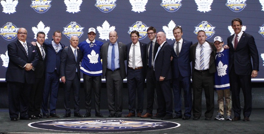 Jun 24, 2016; Buffalo, NY, USA; Auston Matthews poses for a photo with team officials after being selected as the number one overall draft pick by the Toronto Maple Leafs in the first round of the 201 ...