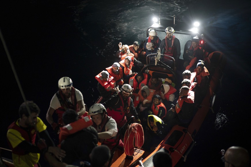 Refugees and migrants are transferred to the SOS Mediterranee Aquarius rescue ship a day after being rescued by members of the Spanish NGO Proactiva Open Arms, after they tried to leave Libya and reac ...