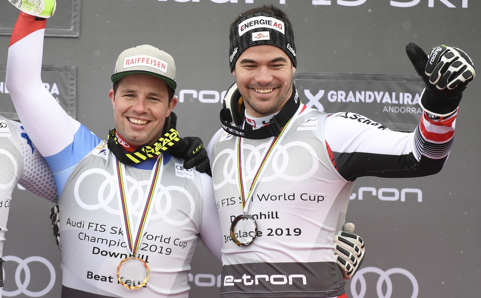 epa07433700 Downhill World Cup winner Beat Feuz (C) of Switzerland, second placed Italy&#039;s Dominik Paris (L) and third placed Austria&#039;s Vincent Kriechmayr (R) pose on the podium after the Men ...