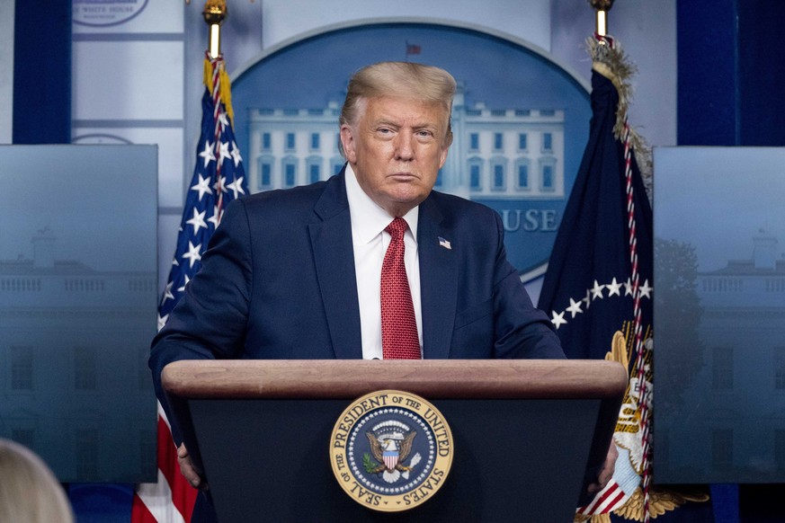 President Donald Trump listens to a question during a news conference in the James Brady Press Briefing Room at the White House, Monday, Aug. 10, 2020, in Washington. Trump briefly left because of a s ...