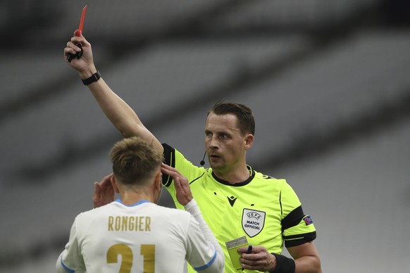 Marseille&#039;s Valentin Rongier reacts after teammate Marseille&#039;s Leonardo Balerdi got a red card from Swedish referee Andreas Ekberg during the Champions League group C soccer match between Ol ...