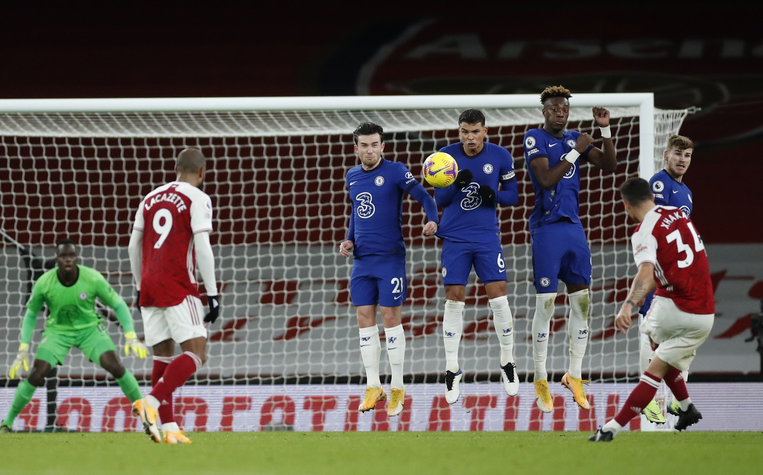Arsenal&#039;s Granit Xhaka, right (34), watches as his free kick goes over the wall scoring his sides 2nd goal of the game during their English Premier League soccer match between Arsenal and Chelsea ...