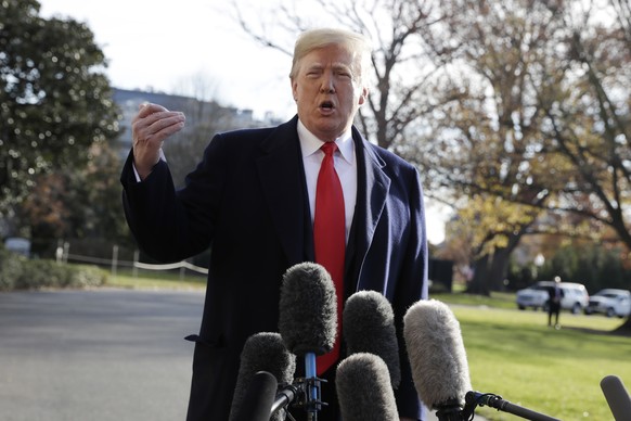 President Donald Trump talks with reporters before departing for Kansas City to address the 2018 Project Safe Neighborhoods National Conference, on the South Lawn of the White House, Friday, Dec. 7, 2 ...