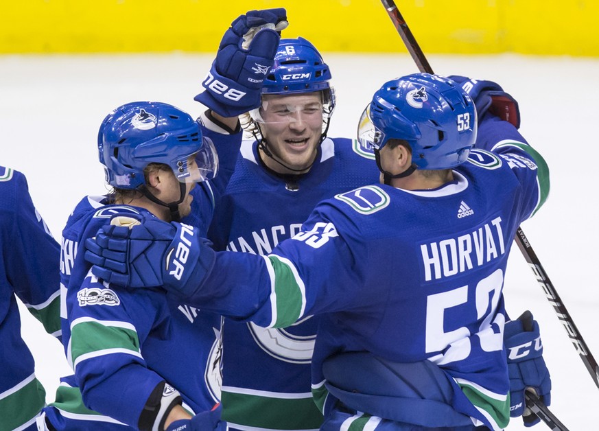 Vancouver Canucks&#039; Sven Baertschi, left, of Switzerland; Brock Boeser, center; and Bo Horvat celebrate Boeser&#039;s second goal against the Pittsburgh Penguins, during the second period of an NH ...