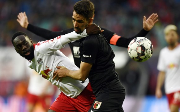 epa07425035 Leipzig&#039;s Jean-Kevin Augustin (L) and Augsburg&#039;s Rani Khedira in action during the German Bundesliga soccer match between RB Leipzig and FC Augsburg, in Leipzig, Germany, 09 Marc ...