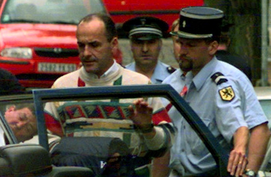 Festina cycling team director Bruno Roussel leaves in a police car the Lille court of Justice, northern France Friday July 24, 1998, after giving his version of events regarding the investigation on F ...