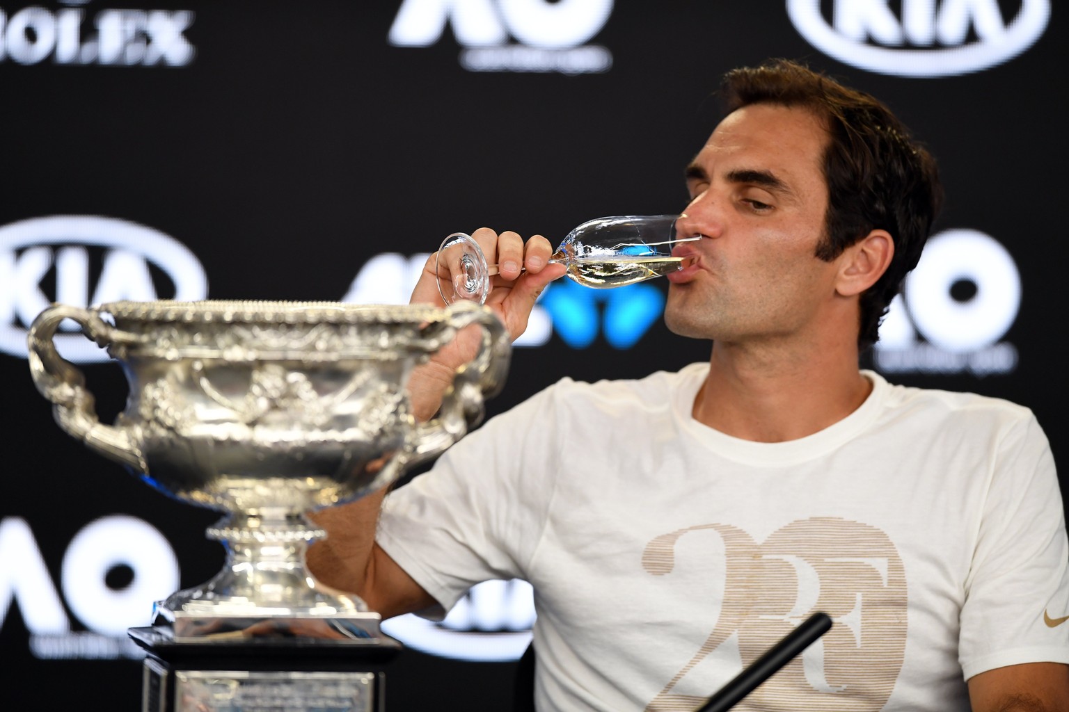 epa06481409 Roger Federer of Switzerland attends a press conference alongside his trophy after winning the men&#039;s singles final against Marin Cilic of Croatia at the Australian Open Grand Slam ten ...