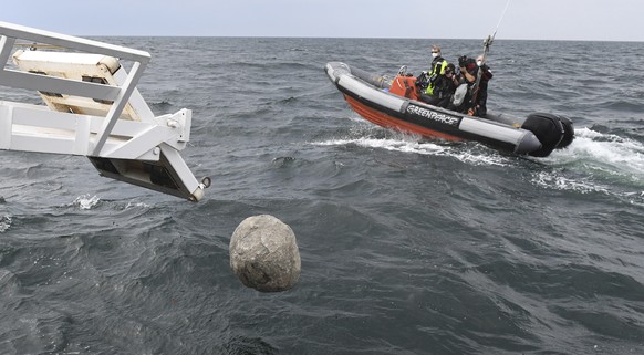 Greenpeace activists sink large blocks of granite into the Baltic Sea off the island of Ruegen near Sassnitz, Germany, Sunday, July 27, 2020. With the action in the Adlergrund Marine Reserve, the envi ...