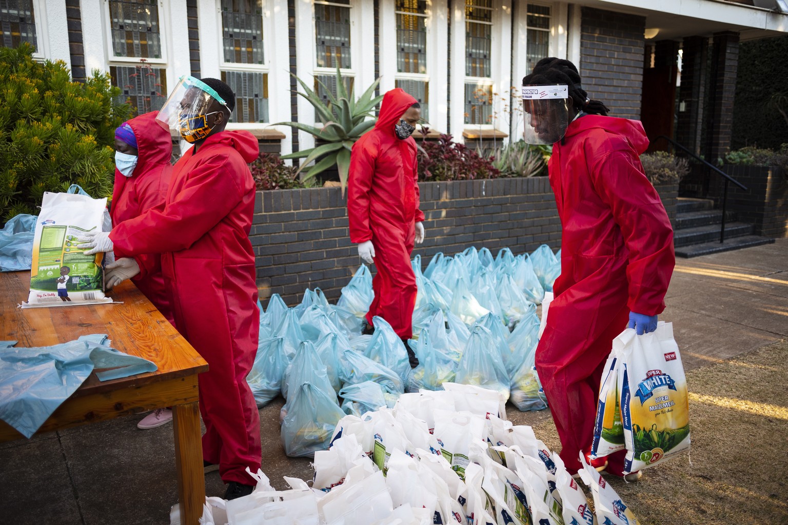 epa08562675 Volunteers prepare to feed local people during the weekly feeding scheme at the Heritage Baptist Church in Melville on the 118 day of lockdown due to the Covid-19 Coronavirus, Johannesburg ...