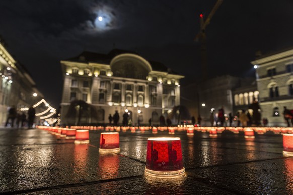 Hunderte Kerzen beleuchten den Bundesplatz vor der Nationalbank, am Samstag, 14. Dezember 2013 in Bern. Mit der Aktion &quot;Eine Million Sterne&quot; wil das Hilfswerk Caritas zur Solidaritaet gegenu ...