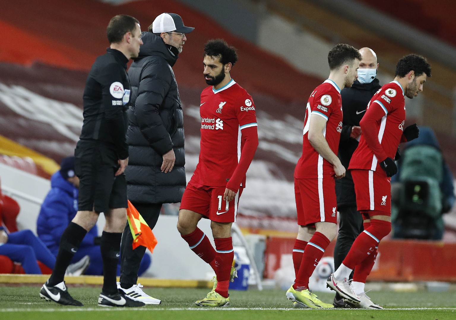 Liverpool&#039;s Mohamed Salah, center, leaves the pitch during the English Premier League soccer match between Liverpool and Chelsea at Anfield stadium in Liverpool, England, Thursday, March 4, 2021. ...