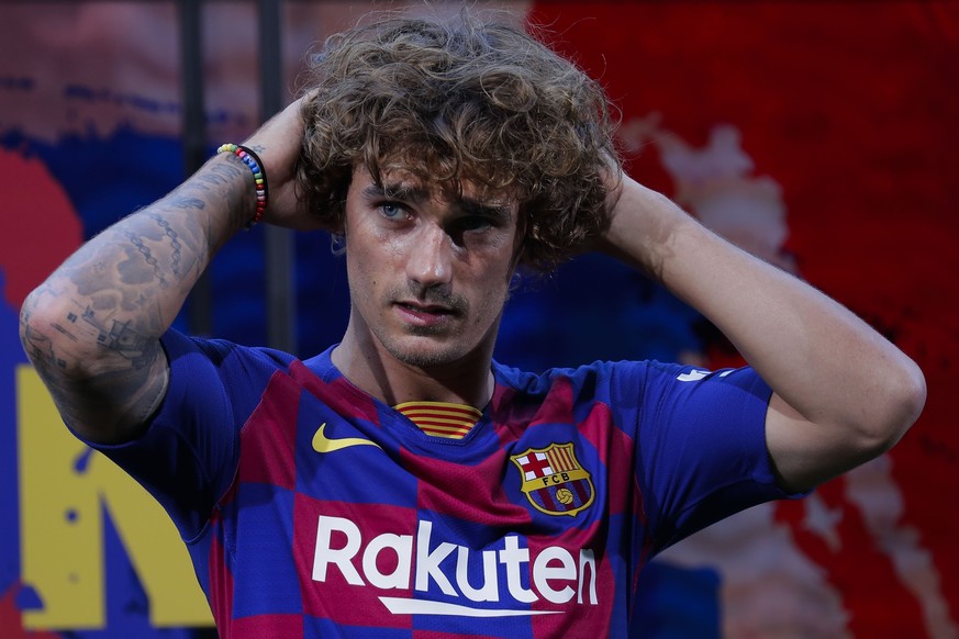 French forward Antoine Griezmann poses for the media during his official presentation after signing for FC Barcelona in Barcelona, Spain, Sunday, July 14, 2019. (AP Photo/Emilio Morenatti)