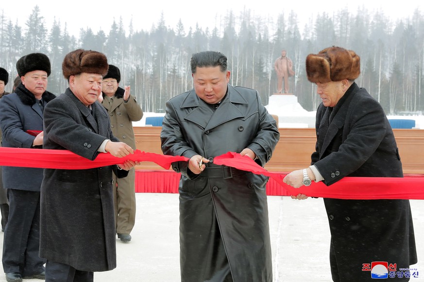 epa08040322 A photo released by the official North Korean Central News Agency (KCNA) shows North Korea&#039;s leader Kim Jong Un (C) cutting a ribbon to open a Township of Samjiyon County, North Korea ...