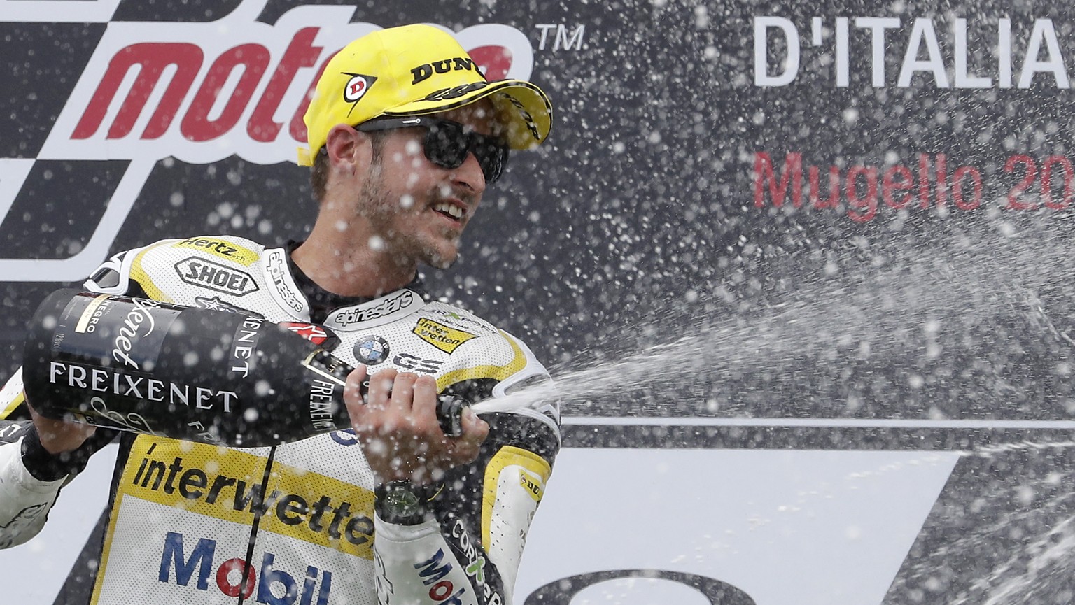 Kalex rider Thomas Luthi, of Switzerland, celebrates on the podium after taking the second place in the Italian Moto 2 grand prix at the Mugello circuit, in Scarperia, Italy, Sunday, June 4, 2017. (AP ...