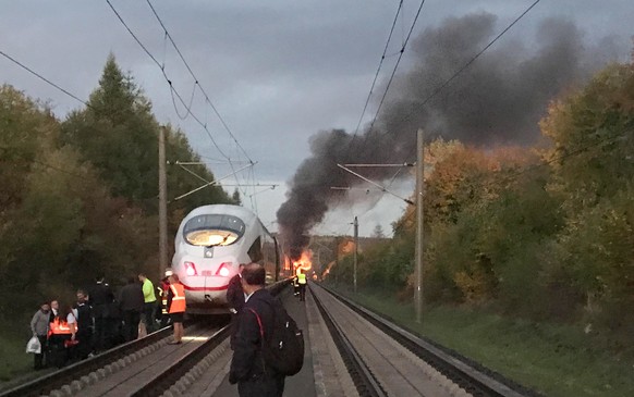 epa07088023 Flames and smoke billowing from a coach of an Inter City Express (ICE) train can be seen in this picture taken by a passenger during the evacuation of the train in the area of Diedorf, nea ...