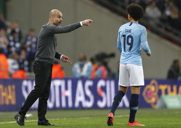 Manchester City manager Pep Guardiola, left, instructs Manchester City&#039;s Leroy Sane, right, during the English League Cup final soccer match between Chelsea and Manchester City at Wembley stadium ...