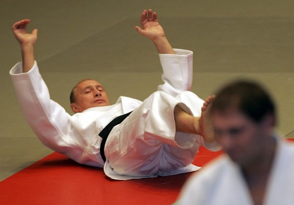 Russian President Vladimir Putin limbers up during a master class at a judo school in St. Petersburg, Saturday, Dec. 24, 2005. Putin, a judo black belt and a KGB veteran of 16 years, showed off his sk ...
