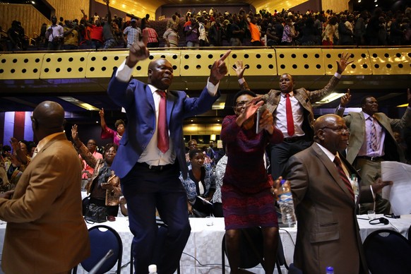epa06342521 People react after the speaker of the House of Assembly Jacob Mudenda read a letter sent to him by Zimbabwean President Robert Mugabe on his resignation at the Harare International Confere ...