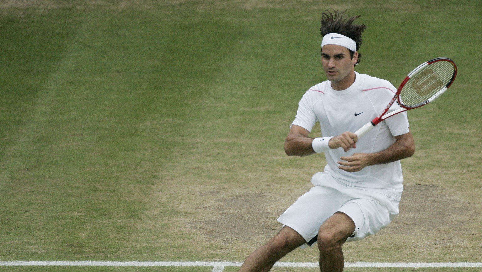 Defending champion Roger Federer of Switzerland returns a shot from Mario Ancic of Croatia, during their Men&#039;s Singles, quarterfinal match, on Wimbledon&#039;s Centre Court, Wednesday, July 5, 20 ...