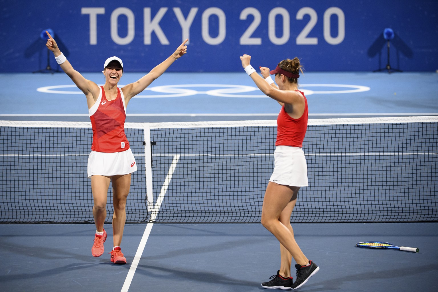 Belinda Bencic, right, and Viktorija Golubic, left, of Switzerland celebrate the winning against Carla Suarez Navarro and Garbine Muguruza of Spain during the women&#039;s doubles tennis second round  ...