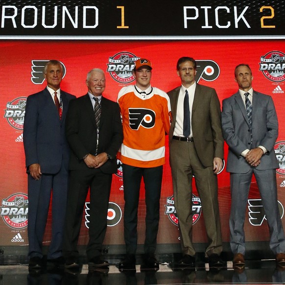 Nolan Patrick, center, wears a Philadelphia Flyers jersey after being selected by the team in the first round of the NHL hockey draft, Friday, June 23, 2017, in Chicago. (AP Photo/Nam Y. Huh)