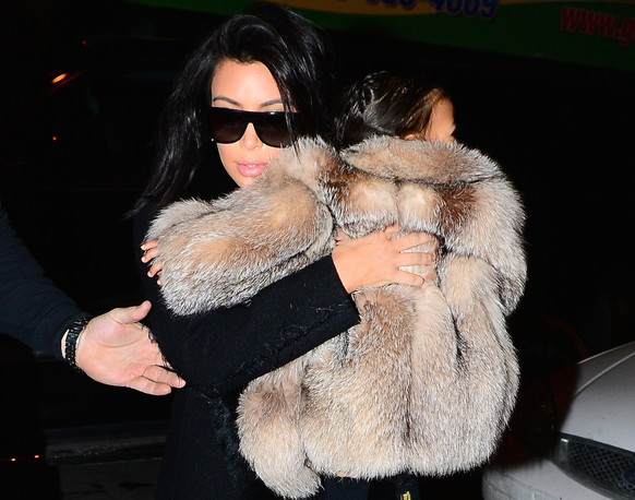 Kim Kardashian dresses North West in a huge fur coat as they head out into the cold NYC night. Temperatures dropped below 30 degrees as they bundled up and walked outside to meet up with Kanye West. K ...