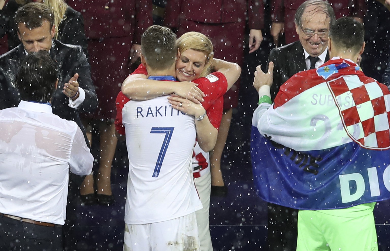 Croatian President Kalinda Grabar-Kitarovic hugs Croatia&#039;s Ivan Rakitic at the end of the final match between France and Croatia at the 2018 soccer World Cup in the Luzhniki Stadium in Moscow, Ru ...