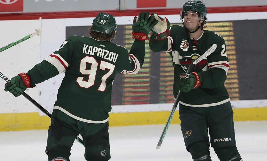 Minnesota Wild&#039;s Kirill Kaprizov (97) high-fives Kevin Fiala (22) after Kaprizov scored a goal against the St. Louis Blues during the third period of an NHL hockey game Thursday, April 29, 2021,  ...