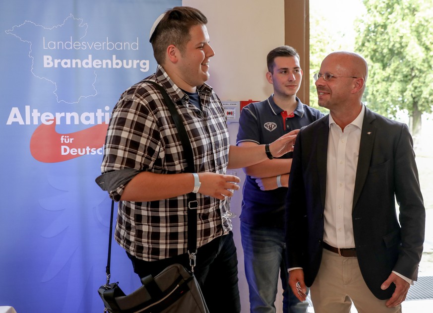 epa07810307 Brandenburg chairman and top candidate of the Alternative for Germany (AfD) right-wing populist party Andreas Kalbitz (R) talks to a supporter of the group &#039;Jews for AfD&#039; on the  ...