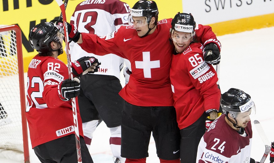 Switzerland&#039;s Nino Niederreiter, centre, celebrates his goal with teammates Simon Moser, left, and Sven Andrighetto, right, after scored the 2:0, during the IIHF 2016 World Championship prelimina ...