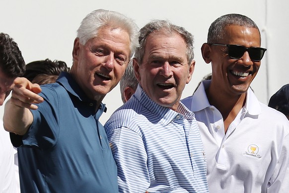 epa08859435 (FILE) - Former US Presidents Bill Clinton (L), George W. Bush (C) and Barack Obama during opening ceremonies for the 2017 Presidents Cup at Liberty National Golf Club in Jersey City, New  ...