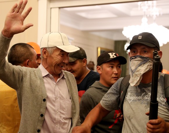 epa07761275 Supporters of Kyrgyz former President Almazbek Atambayev guard his house during an operation of state security forces to detain Atambayev, who was accused of corruption, in the village of  ...