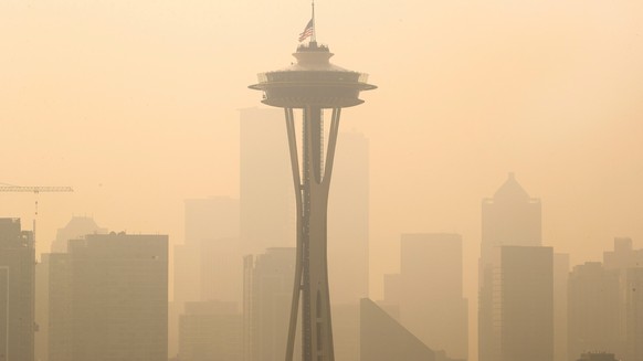 An American flag on top the Space Needle was lowered to half-staff today by the Seattle Fire Department to remember those who lost their lives on 9/11, Friday, Sept. 11, 2020. Thick smoke from wildfir ...