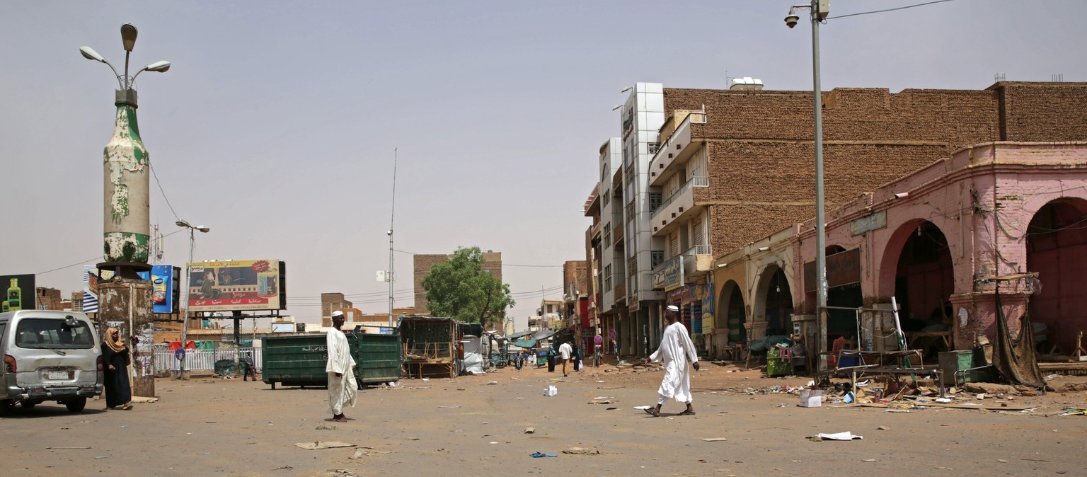 epa07636516 People walk down an empty street closed in the Omdurman market, near Khartoum, Sudan, 08 June 2019. Sudanese protest group called on demonstrators participating in the first day of the &#0 ...