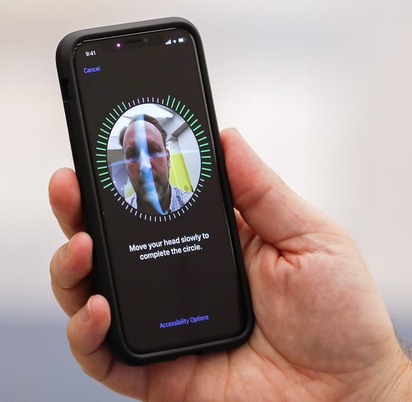 epa06306443 A customer sets up his the newly purchased iPhone X using facial recognition at an Apple Store in the Perimeter Mall in Atlanta, Georgia, USA, 03 November 2017. Apple launched its new iPho ...