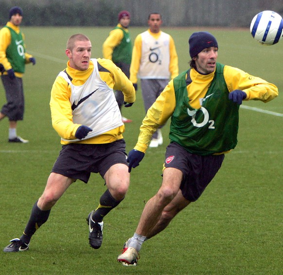 Arsenal&#039;s Philippe Senderos, left, looks on as teammate Robert Pires takes the ball away during a training session at the Arsenal training ground in London Colney, England Tuesday March 7 2006. A ...