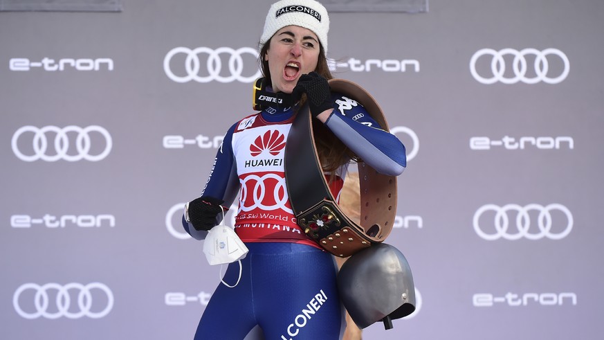 Italy&#039;s Sofia Goggia celebrates on the podium after winning an alpine ski, women&#039;s World Cup downhill in Crans Montana, Switzerland, Friday, Jan. 22, 2021. (AP Photo/Marco Tacca)